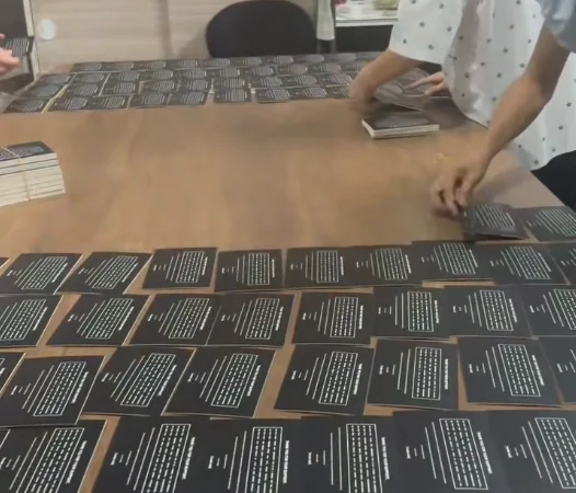 Workers placing the first layer of components during the product kitting process