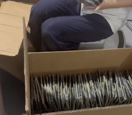Warehouse worker counting product kits before carton packing