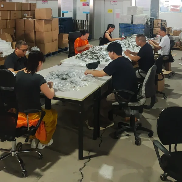 Seven warehouse workers assembling sewing kits during a Product Kitting project in China