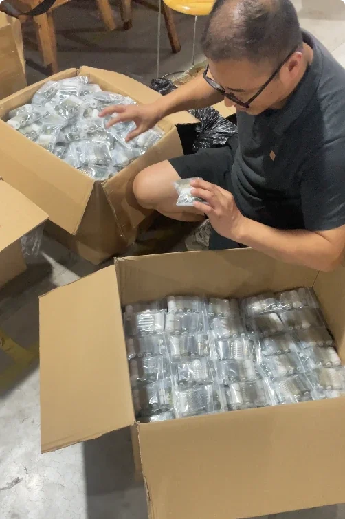 Warehouse supervisor inspecting completed sewing kit assemblies before packing
